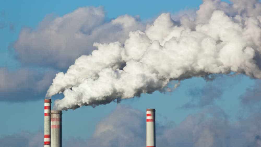 shows plumes of chemical and dangerous smoke being released from factory chimneys